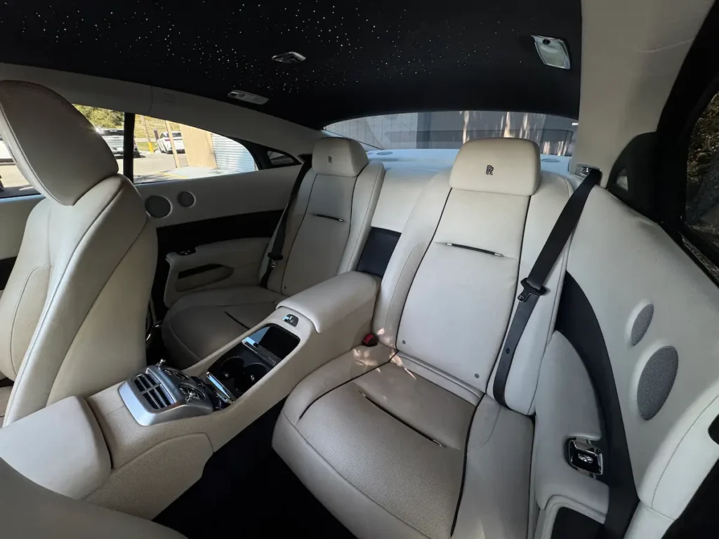 Rear seating area of a 2016 Rolls-Royce Wraith with starlight headliner