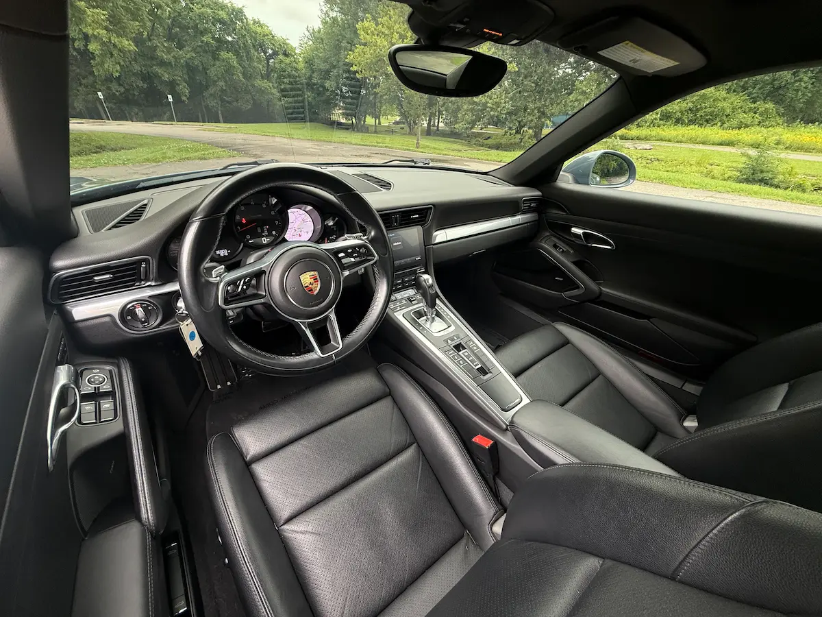 Black leather interior and PDK controls in a 2017 Porsche 911 Carrera