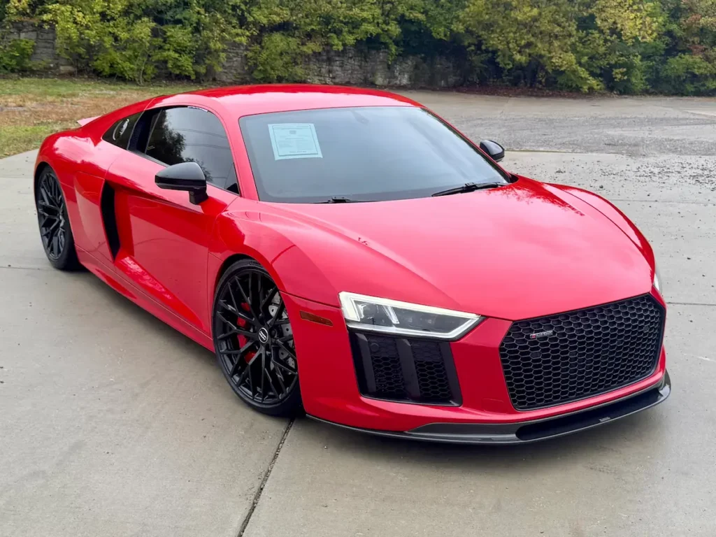 2018 Audi R8 V10 in red shown from front angle with black wheels and aggressive styling.