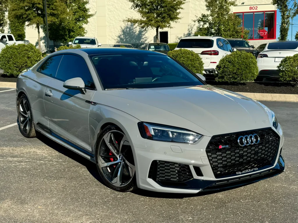 2018 Audi RS5 gray exterior at AutoPro Nashville, parked under sunlight highlighting its refined curves and sporty design.