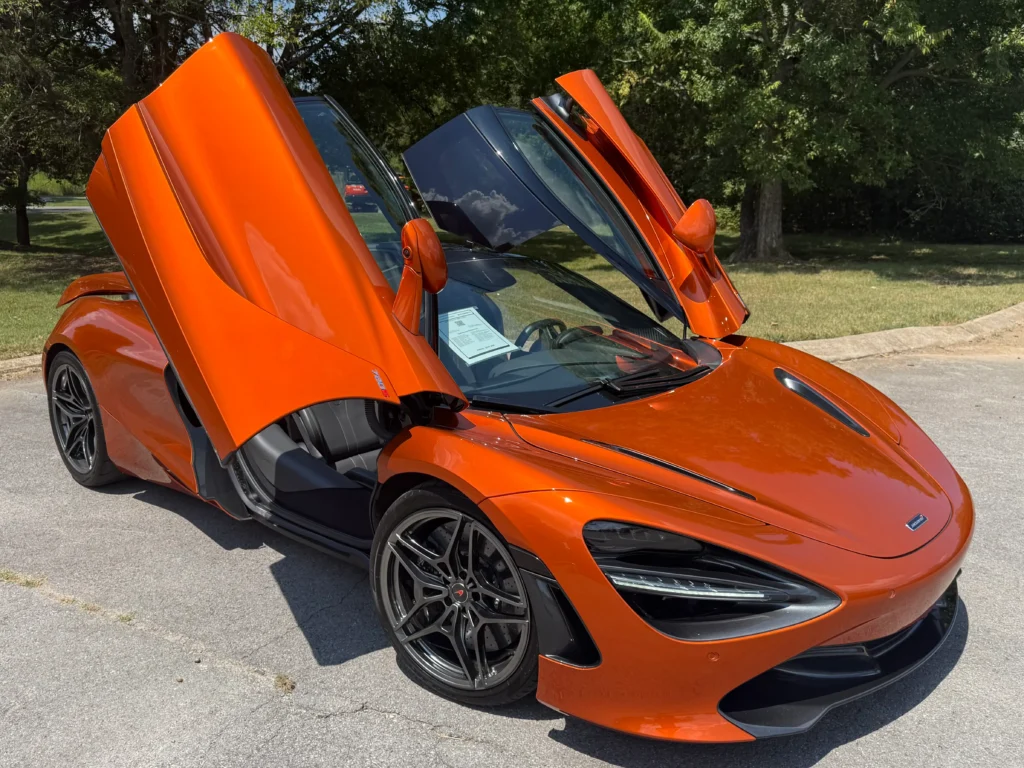McLaren 720S 2018 Luxury trim with butterfly doors open in bright orange finish.