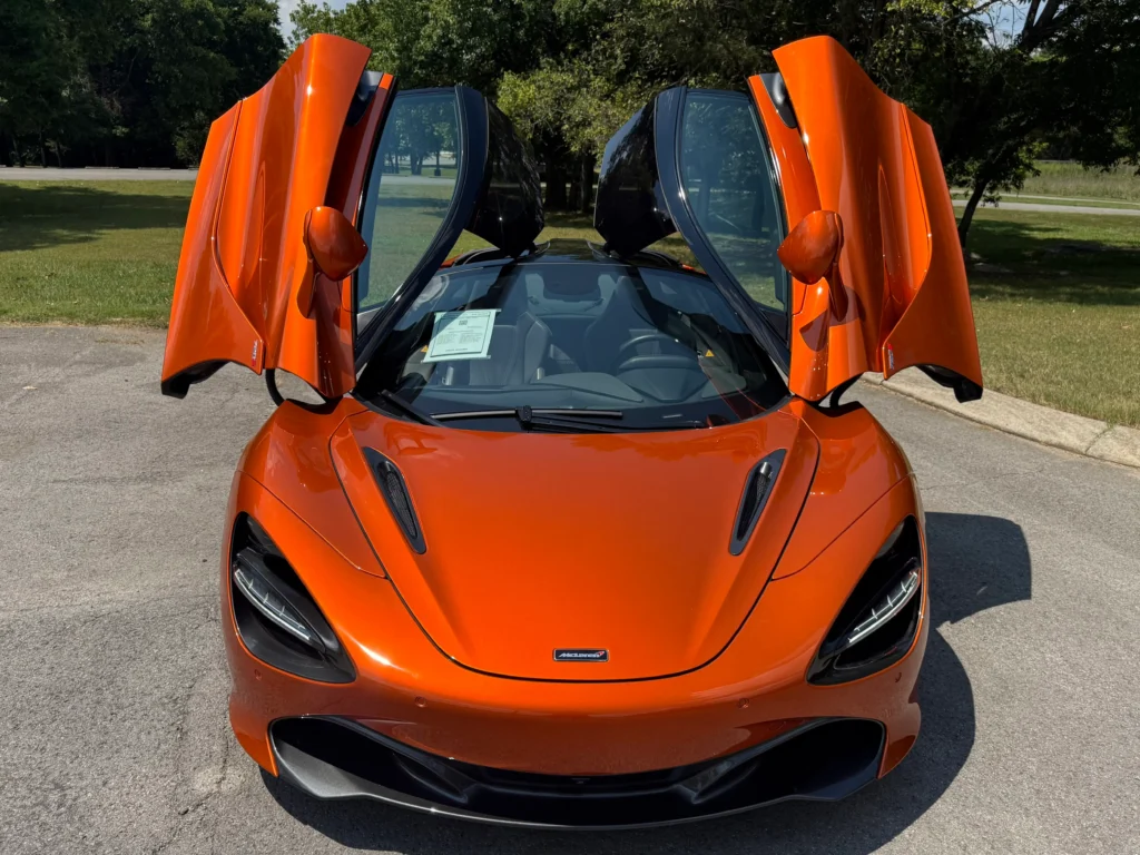 Front view of 2018 McLaren 720S Luxury in orange with dihedral doors open.