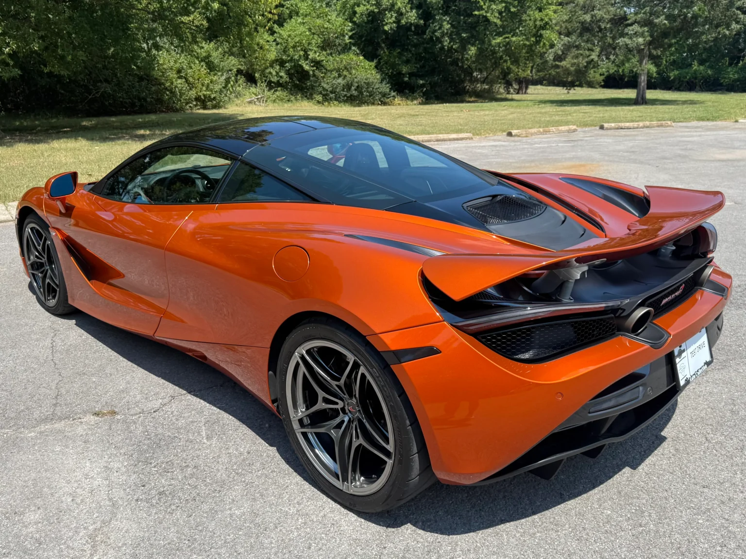 Rear view of orange McLaren 720S 2018 Luxury trim with black accents.