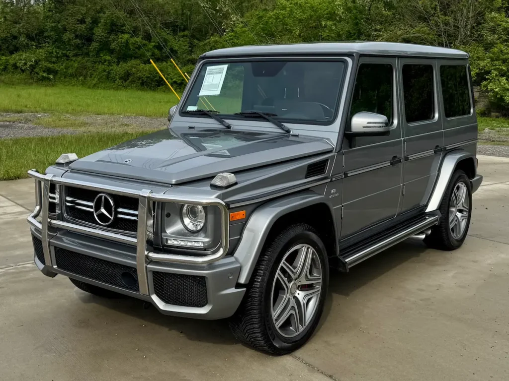 2018 Mercedes-Benz G63 AMG front three-quarter view in silver with brush guard and AMG wheels