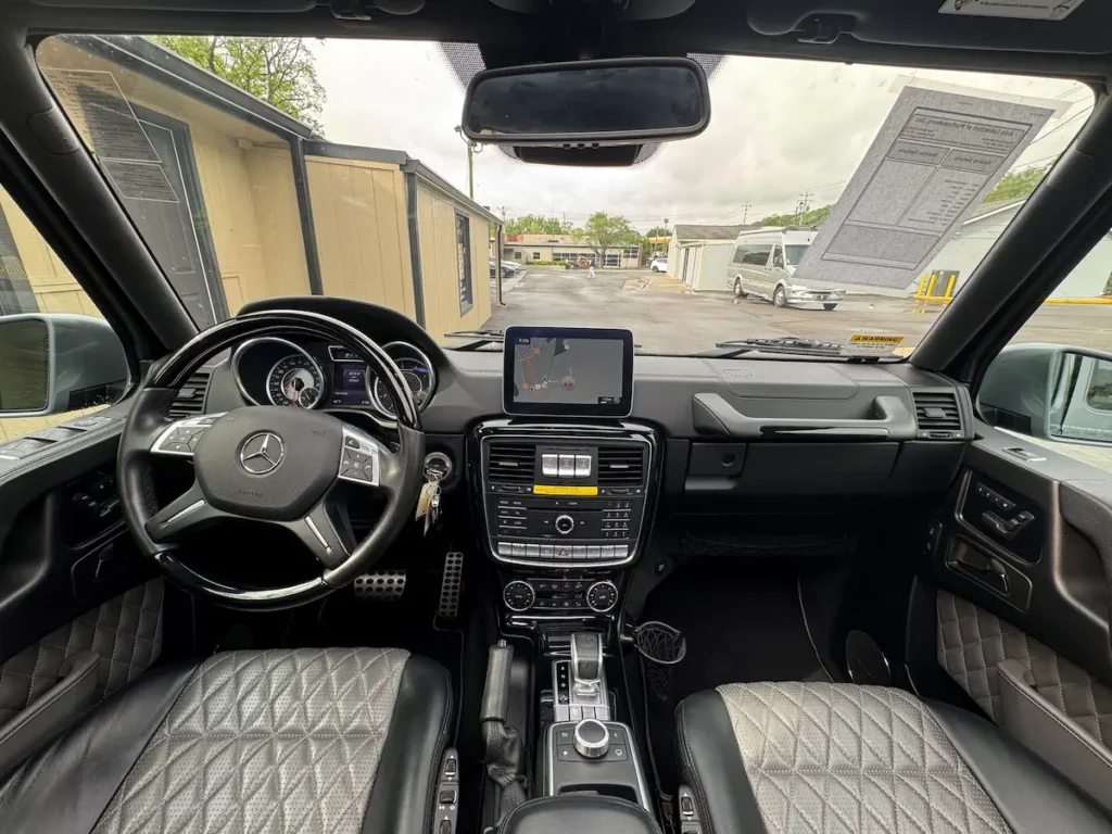 2018 Mercedes-Benz G63 AMG interior dashboard with analog gauges and center display screen