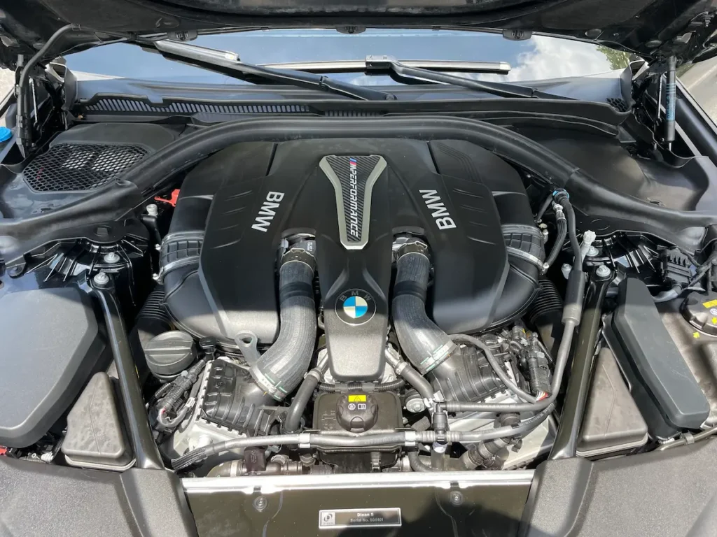 BMW M550i twin-turbo V8 engine bay with M Performance branding.