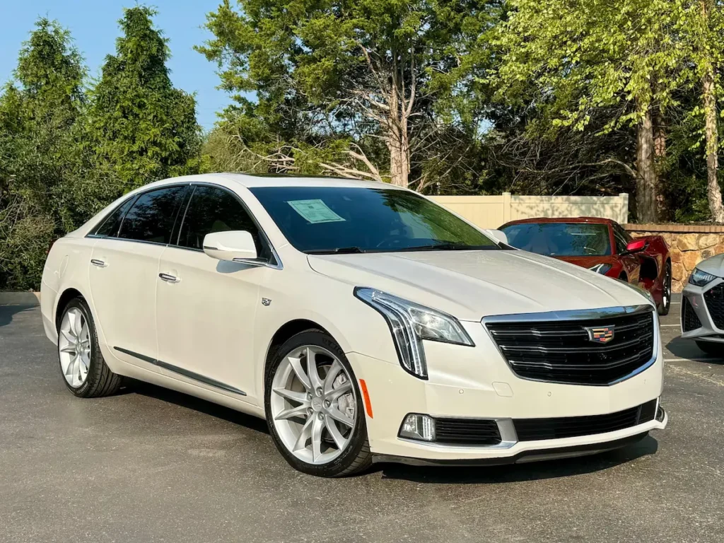 Front angle view of a white 2019 Cadillac XTS with signature grille and LED headlamps.