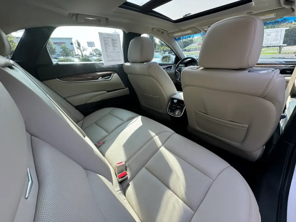 Rear interior seating of a 2019 Cadillac XTS showing spacious legroom and high-end materials.