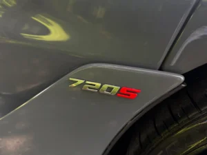 Close-up of 720S badge on gray McLaren 720S Performance trim.