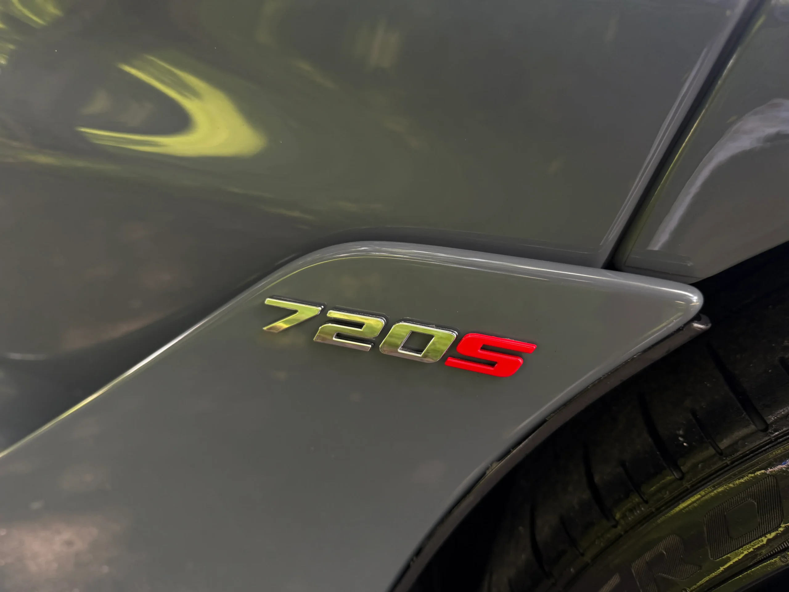 Close-up of 720S badge on gray McLaren 720S Performance trim.