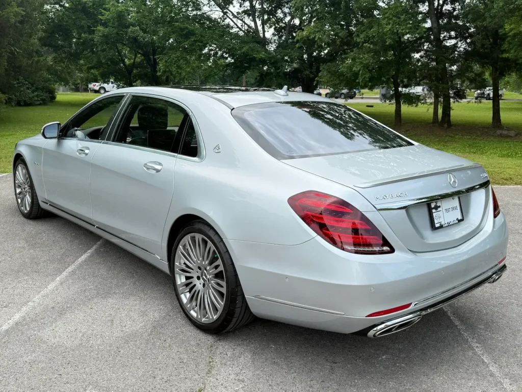 Rear view of 2019 Mercedes-Benz S560 Maybach silver sedan with Maybach emblem and chrome accents.