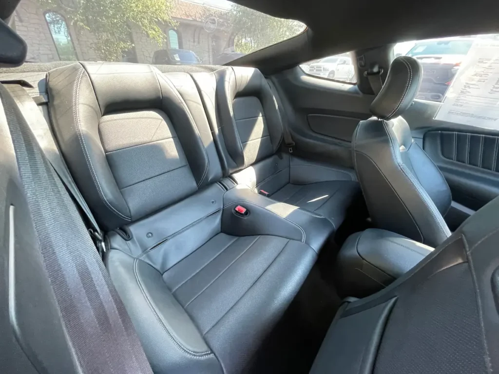 Rear seat view of a 2020 Ford Mustang GT with black leather interior.