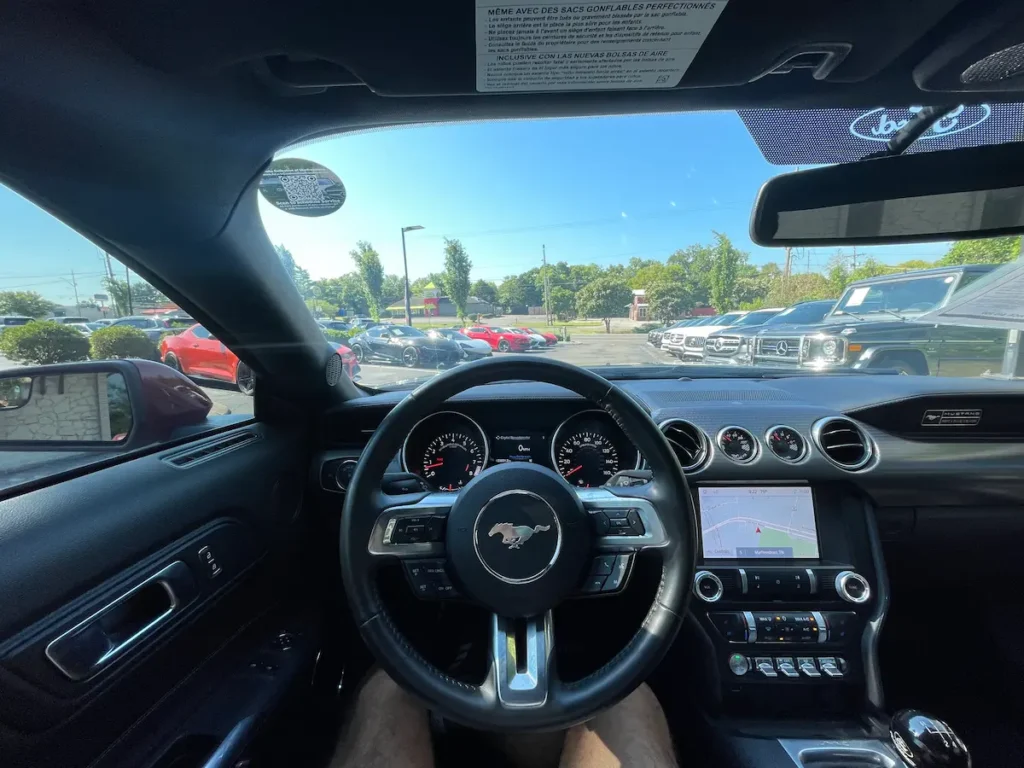 Driver cockpit of a 2020 Ford Mustang GT showing gauges and center display.
