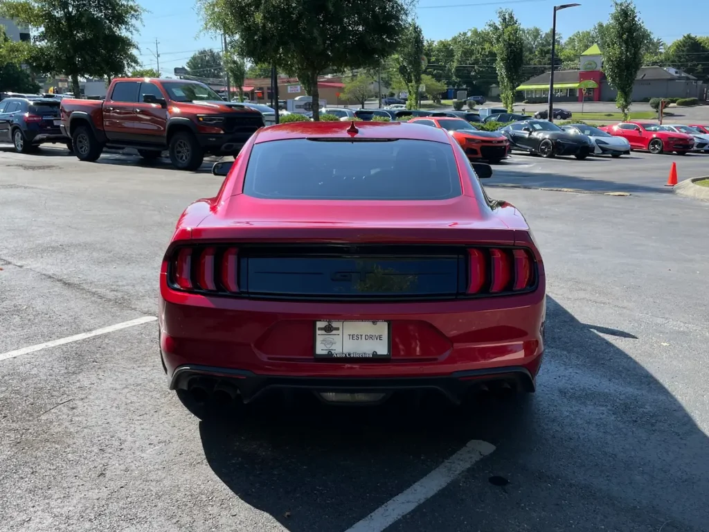 Rear view of a 2020 Ford Mustang GT with smoked taillights and dual exhaust.