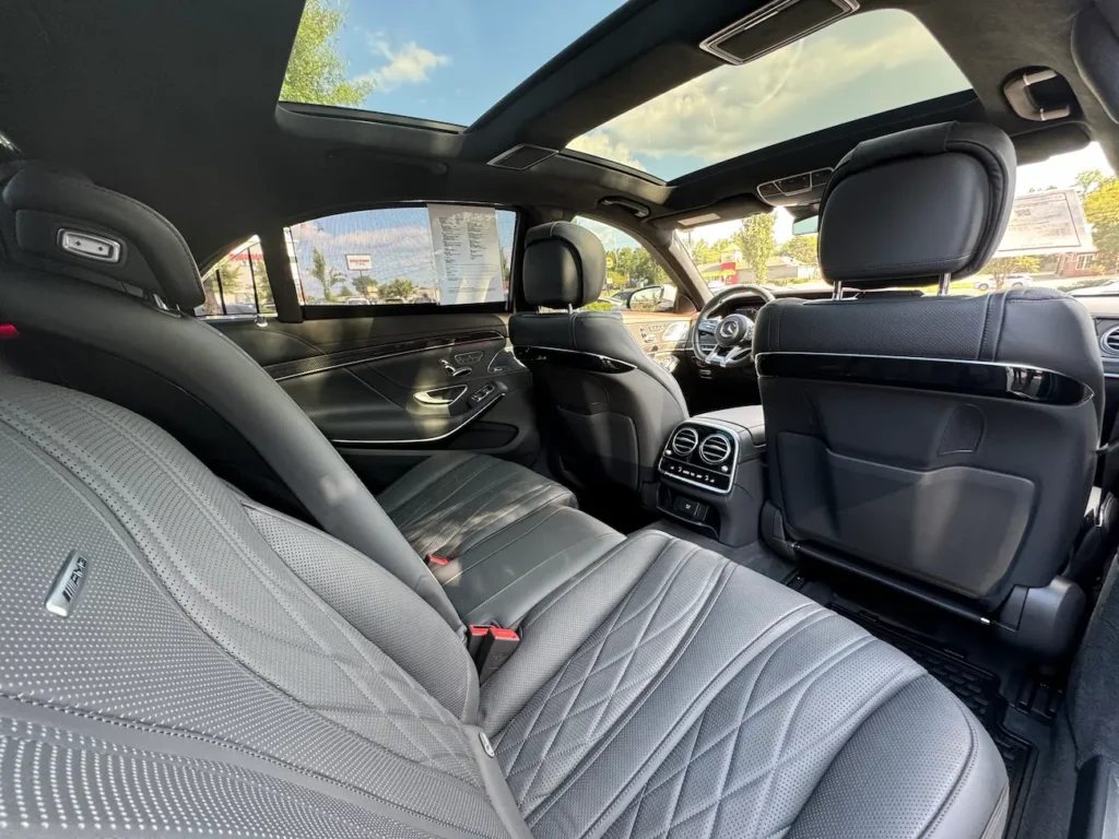 Rear seats of the 2020 Mercedes-Benz S63 AMG with quilted black leather and panoramic sunroof.