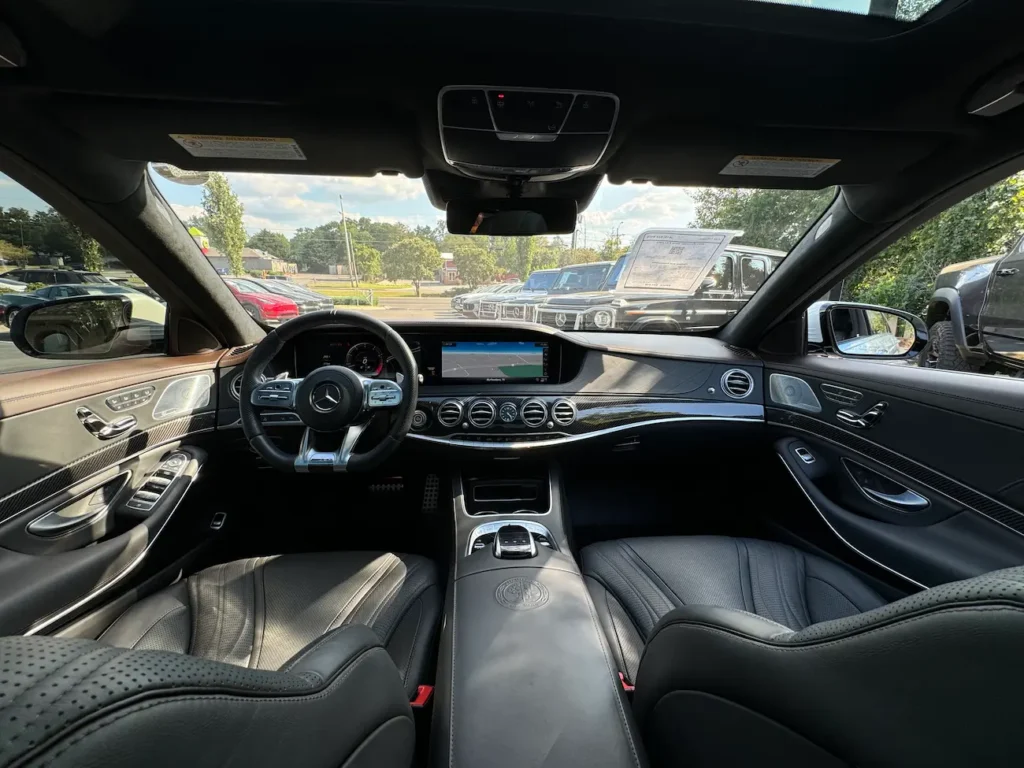Dashboard and steering view of 2020 Mercedes-Benz S63 AMG with digital display and luxury materials.