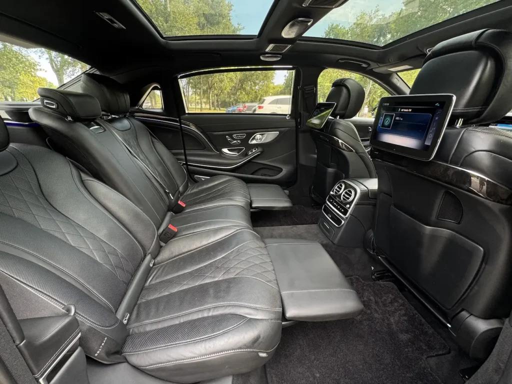 Rear seating of 2020 Mercedes-Benz S650 Maybach with executive-class comfort and entertainment screens.