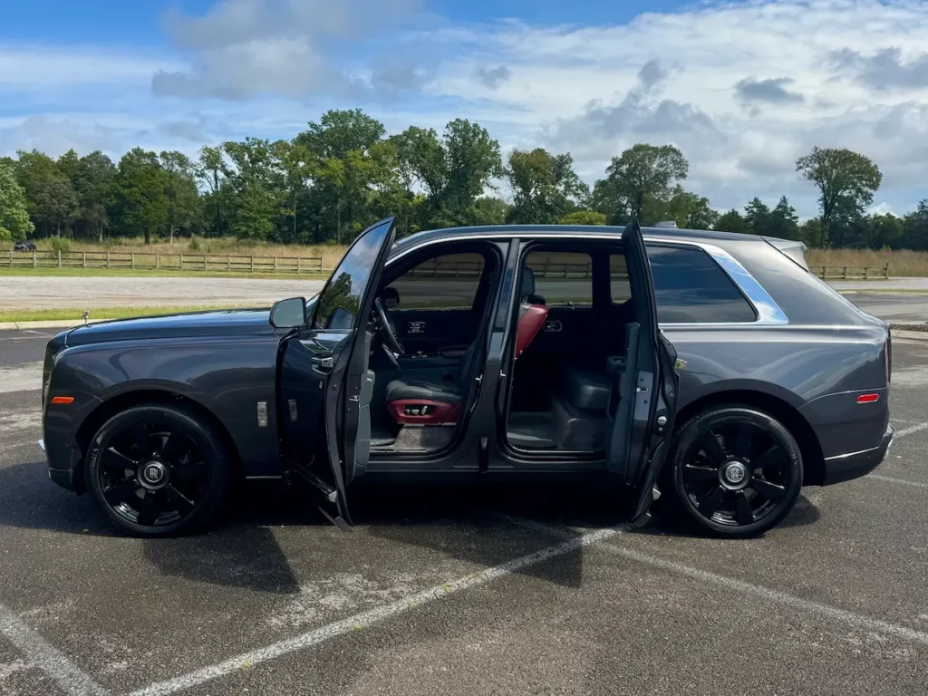 Side profile of a 2020 Rolls-Royce Cullinan with doors open