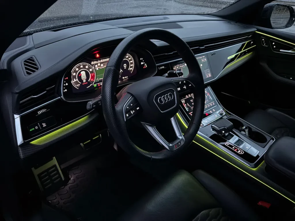 2021 Audi RSQ8 interior featuring ambient lighting, digital cockpit, and carbon-fiber accents.