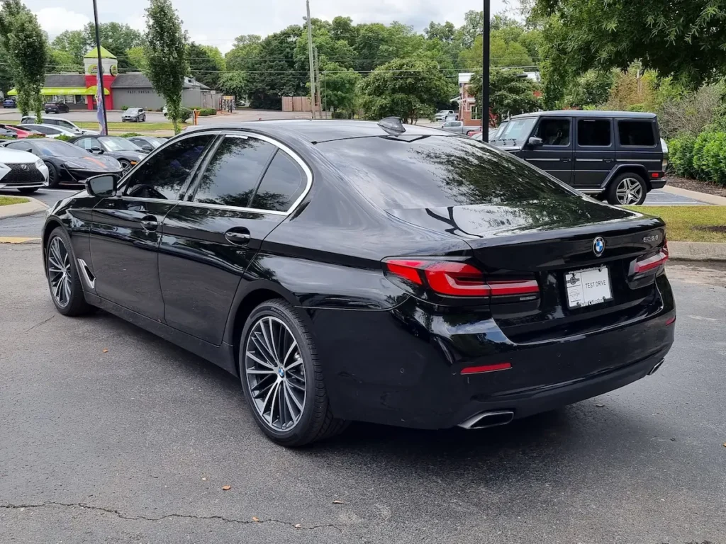 Black BMW 530i rear exterior view showing LED taillights, trunk design, and alloy wheels.