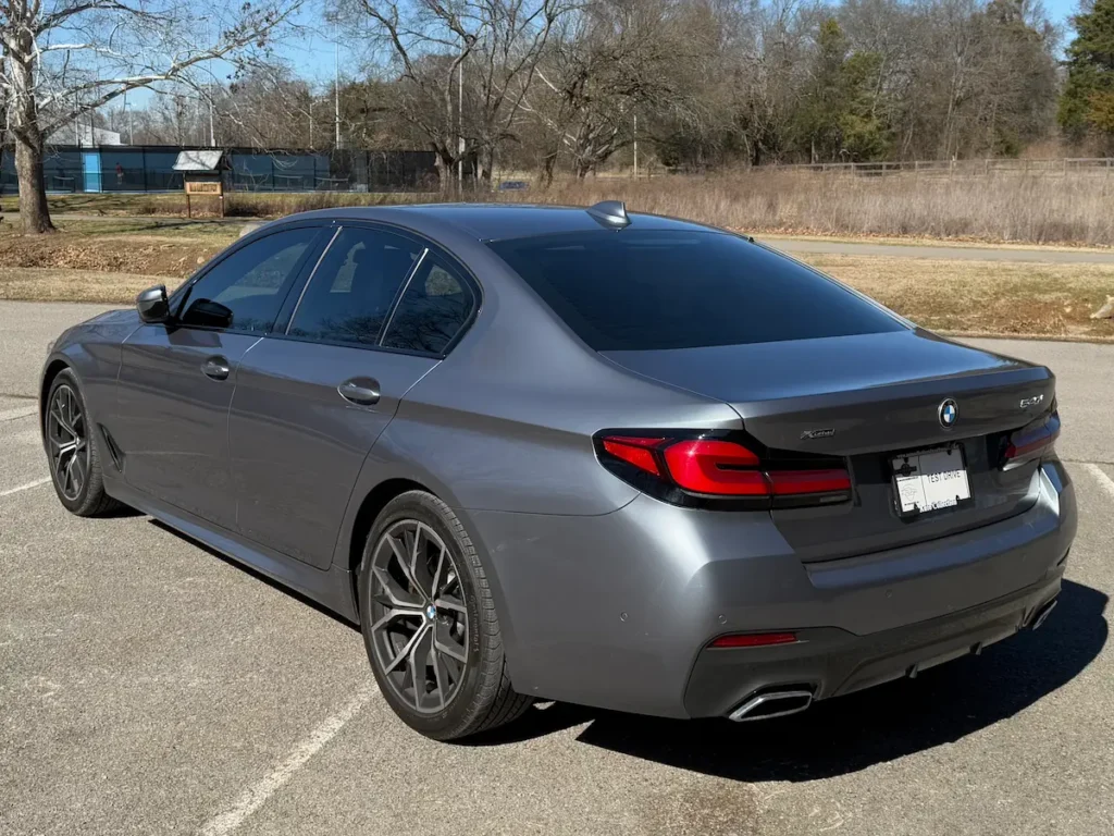 BMW 540i xDrive rear exterior view showing taillights and dual exhaust outlets.