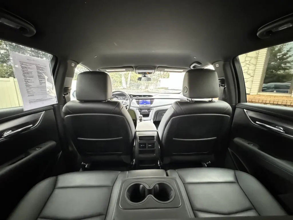 Rear seating view of a 2021 Cadillac XT5 with spacious legroom and premium leather interior.