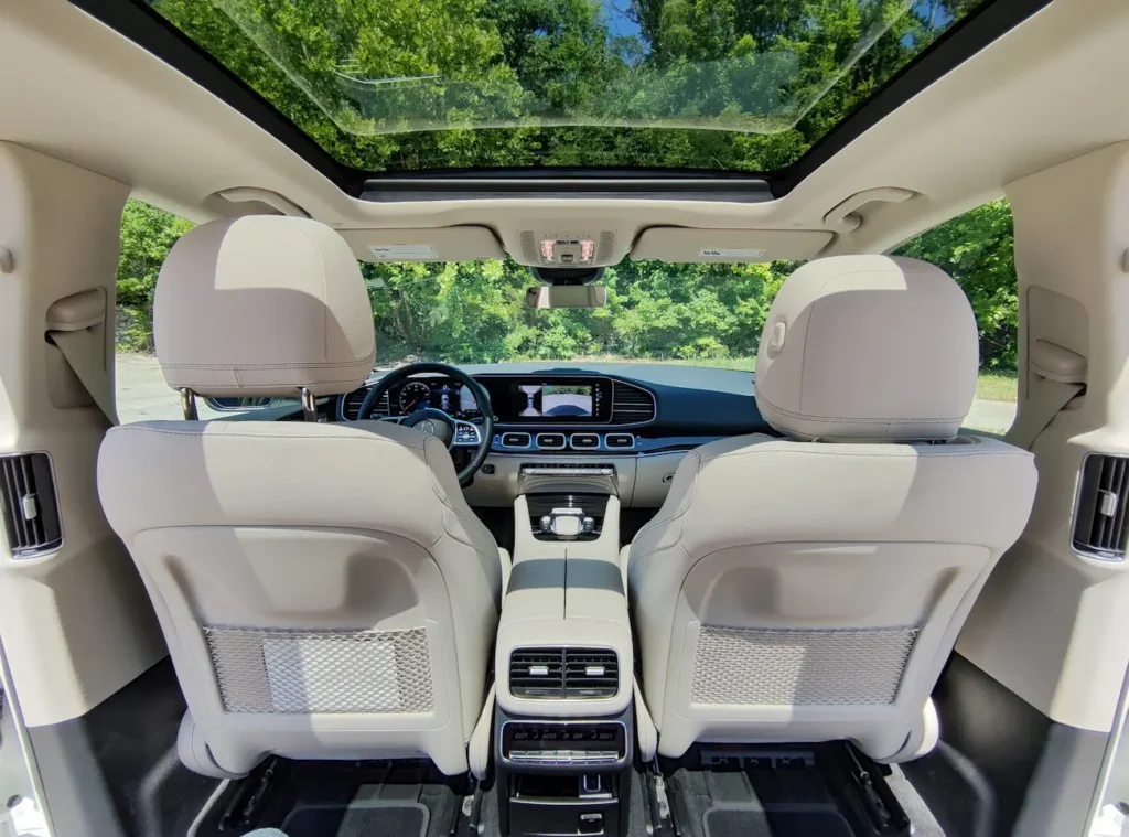 Interior of 2021 Mercedes-Benz GLE 450 featuring light leather seats and panoramic sunroof.