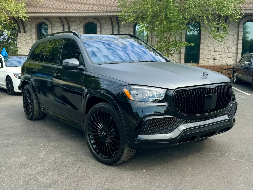 Black 2021 Mercedes-Benz GLS 600 Maybach parked outside, featuring a bold front grille and custom black wheels.