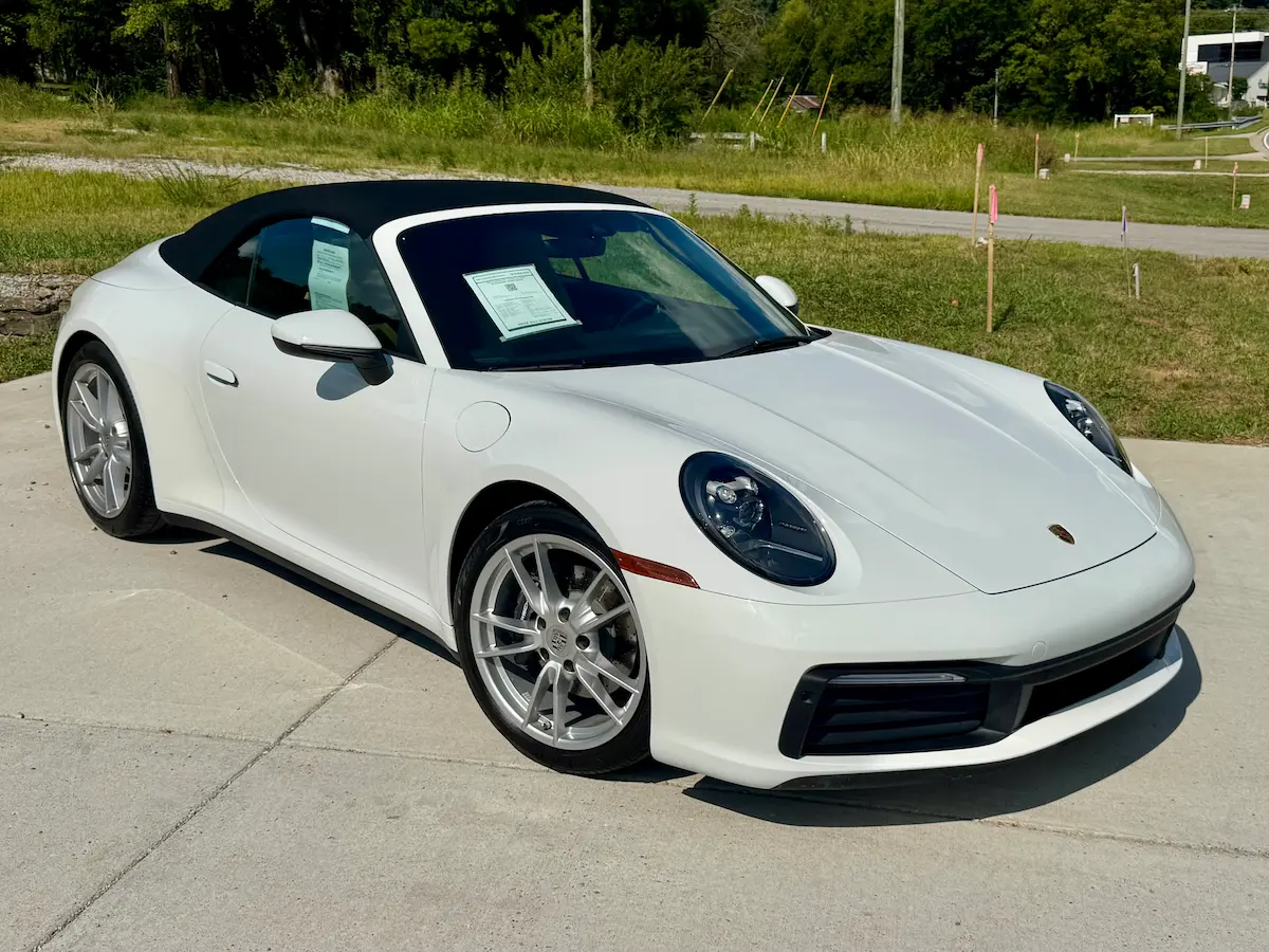 White 2021 Porsche 911 Carrera Cabriolet with its black soft top closed