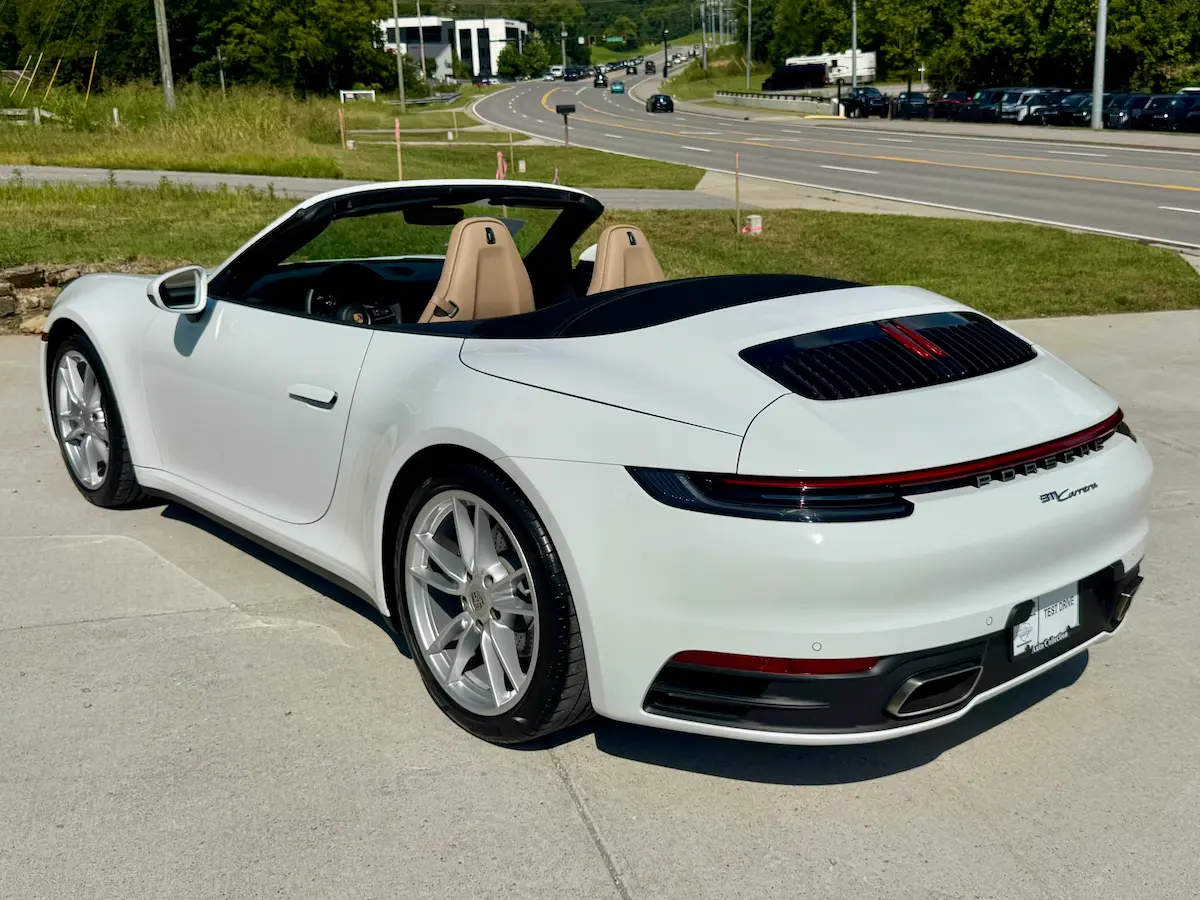 Rear view of a white 2021 Porsche 911 Carrera Cabriolet with tan seats