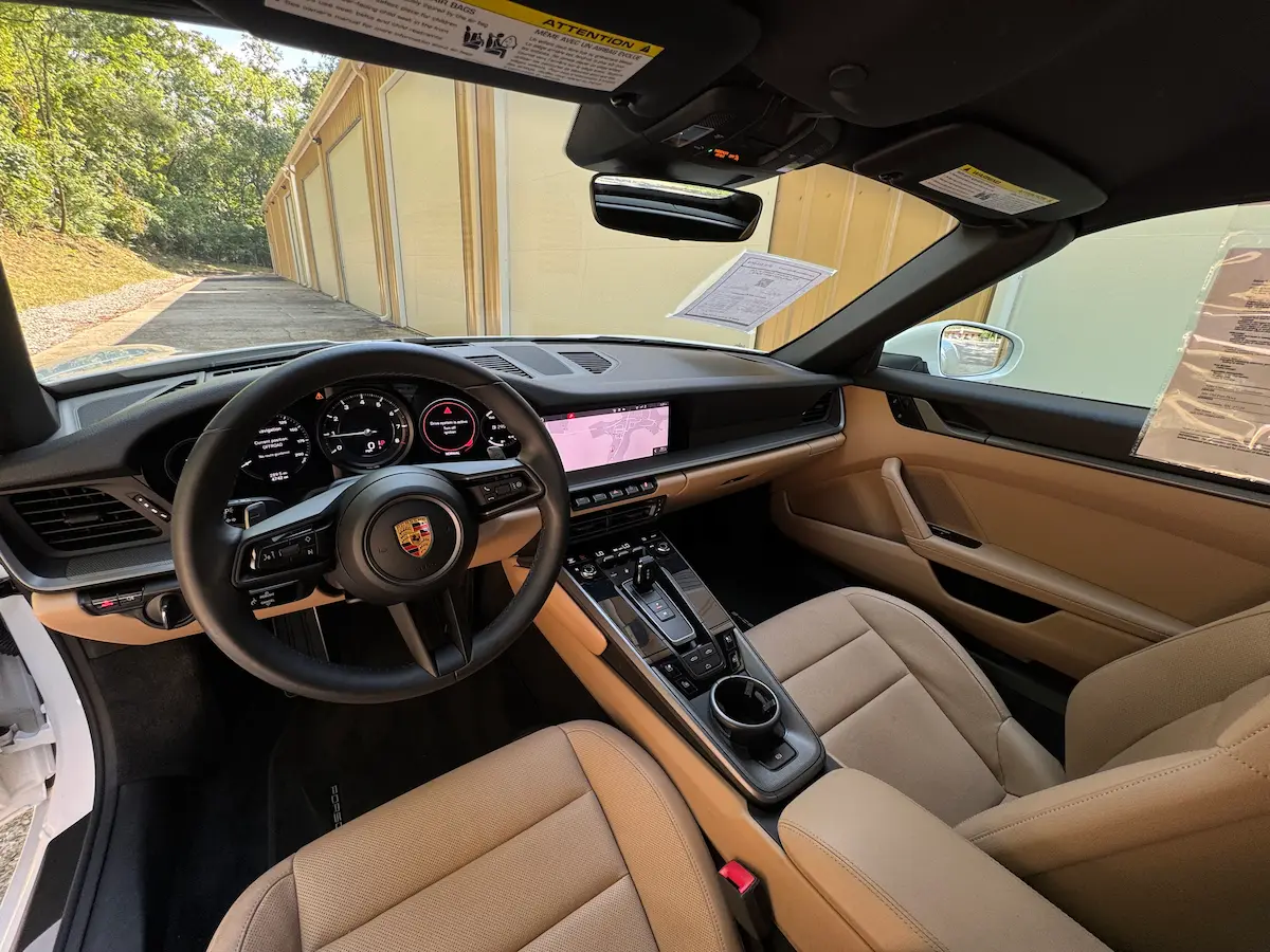 Tan leather interior and digital displays in a 2021 Porsche 911 Carrera