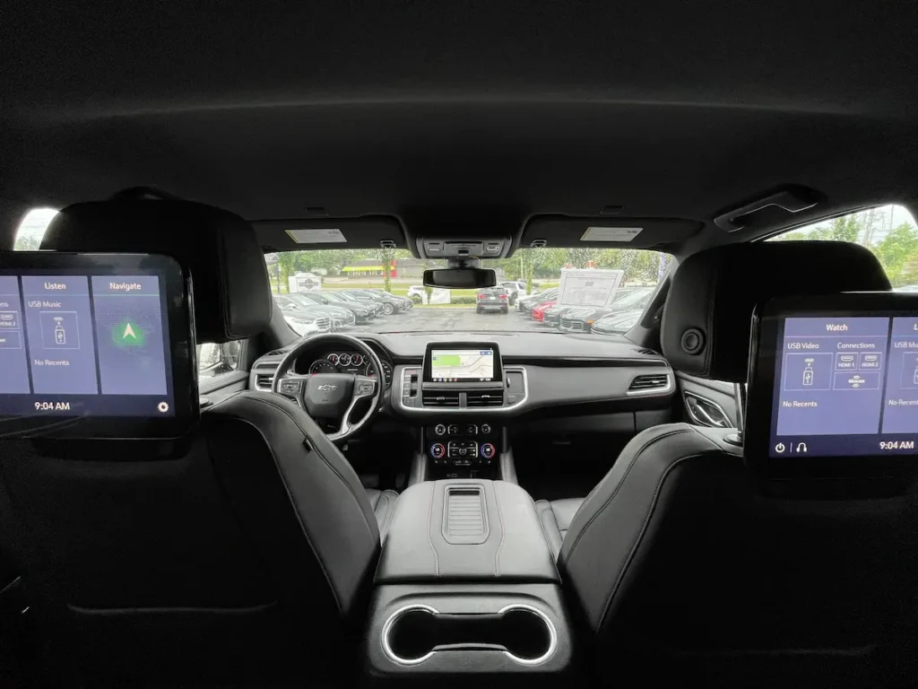 Interior view of a 2021 Chevrolet Tahoe RST showing rear-seat entertainment screens and front navigation display.