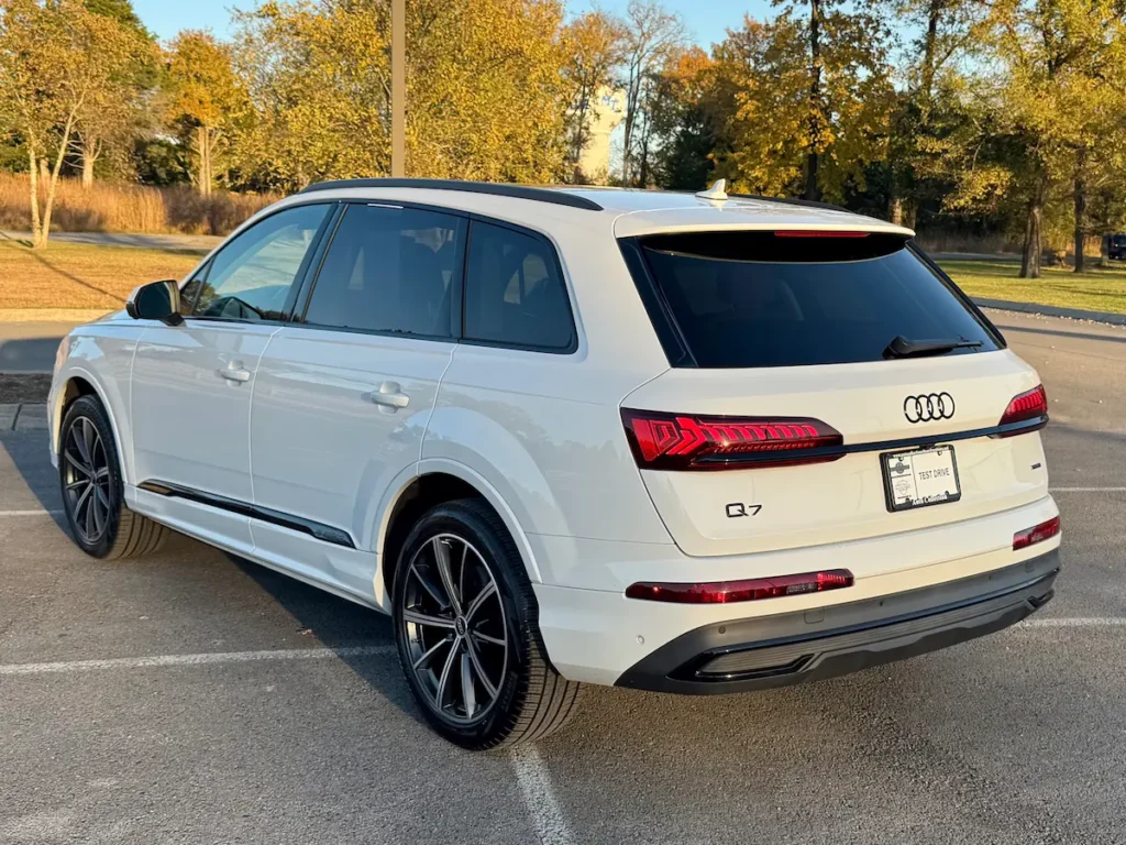 2022 Audi Q7 in white viewed from the rear showing full-width LED taillights and clean body lines.