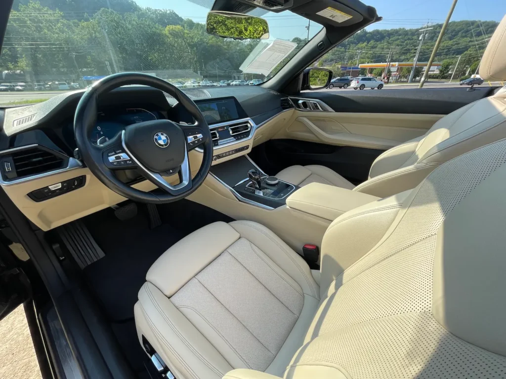 2022 BMW 430i Convertible interior with beige leather seats and advanced infotainment system.