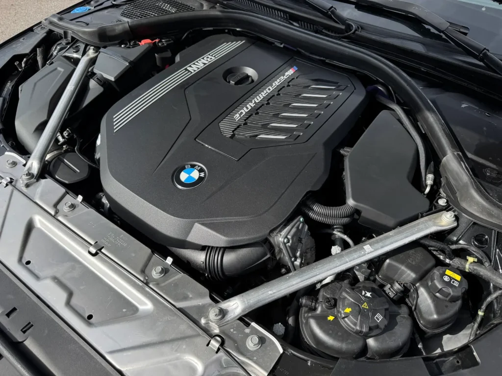 Close-up view of the BMW M440i engine showcasing the turbocharged inline-6 powertrain.