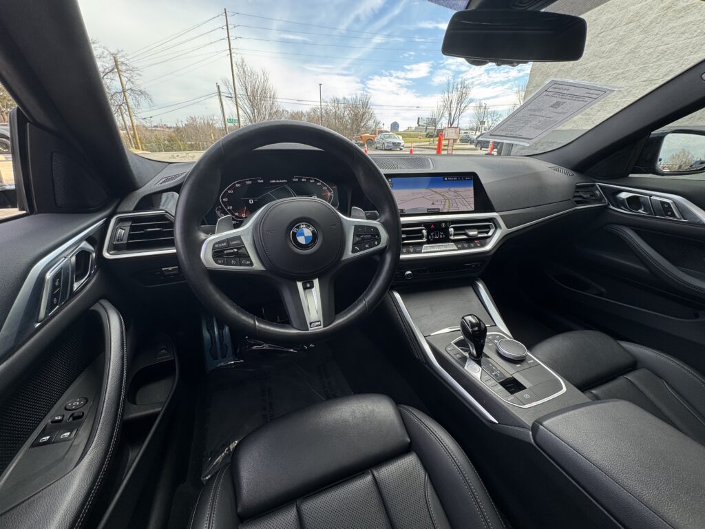 2022 BMW M440i interior with black leather seats and digital dashboard.