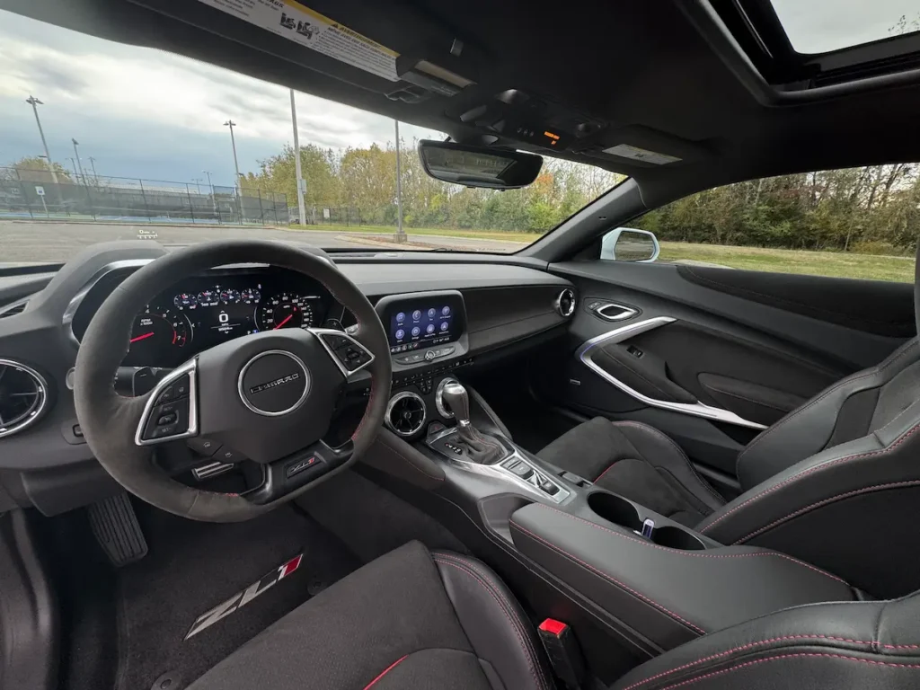 Interior of a 2022 Chevrolet Camaro ZL1 featuring performance seats, digital gauges, and touchscreen.