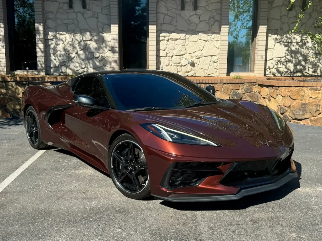 2022 Chevrolet Corvette Stingray Convertible 3LT Z51 in metallic burgundy parked outdoors.