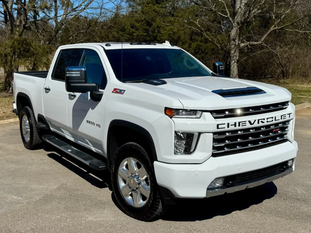 Front angle view of a 2022 Chevrolet Silverado 2500HD LTZ Z71 Chrome Sport Edition in white with bold grille and off-road styling.