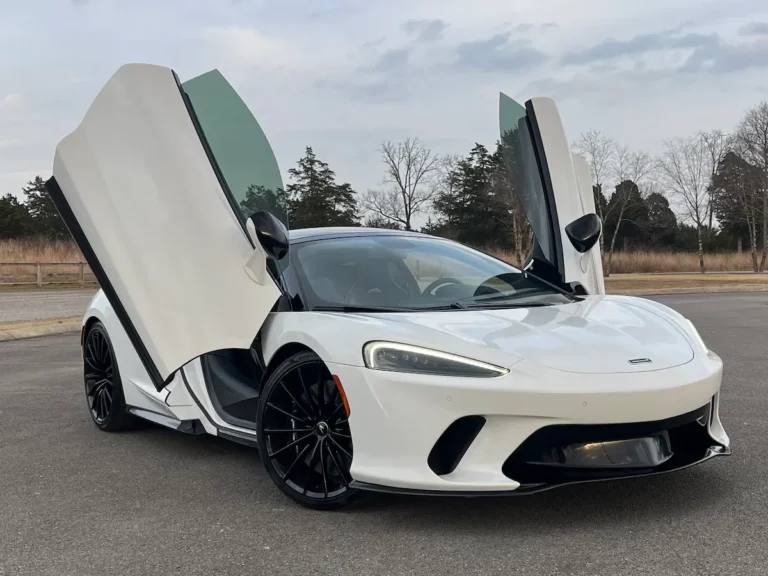 White 2022 McLaren GT with dihedral doors open