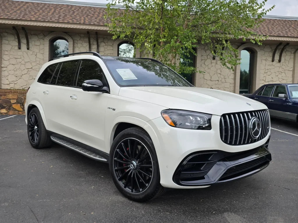 White 2022 Mercedes-Benz GLS 63 AMG parked outside, featuring an aggressive front grille and black multi-spoke wheels.