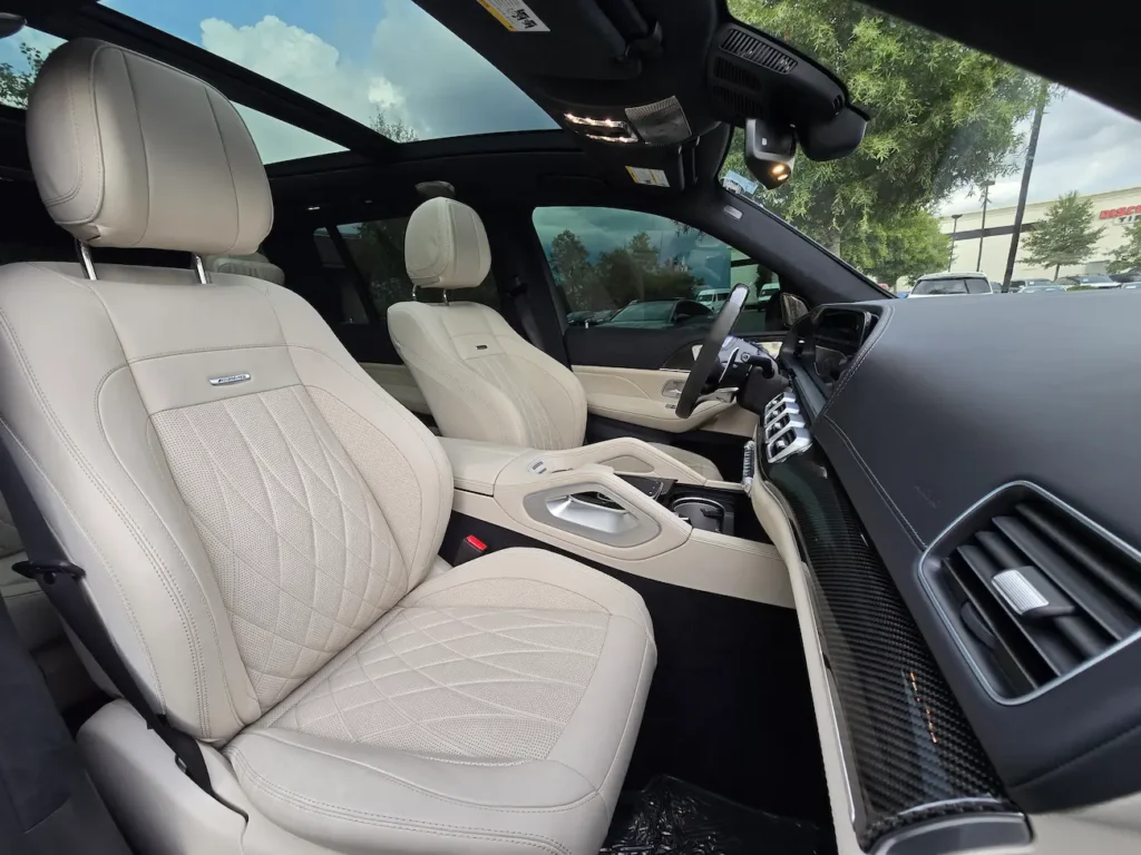 Front seats of 2022 Mercedes-Benz GLS 63 AMG featuring diamond-stitched Nappa leather upholstery and AMG badging.
