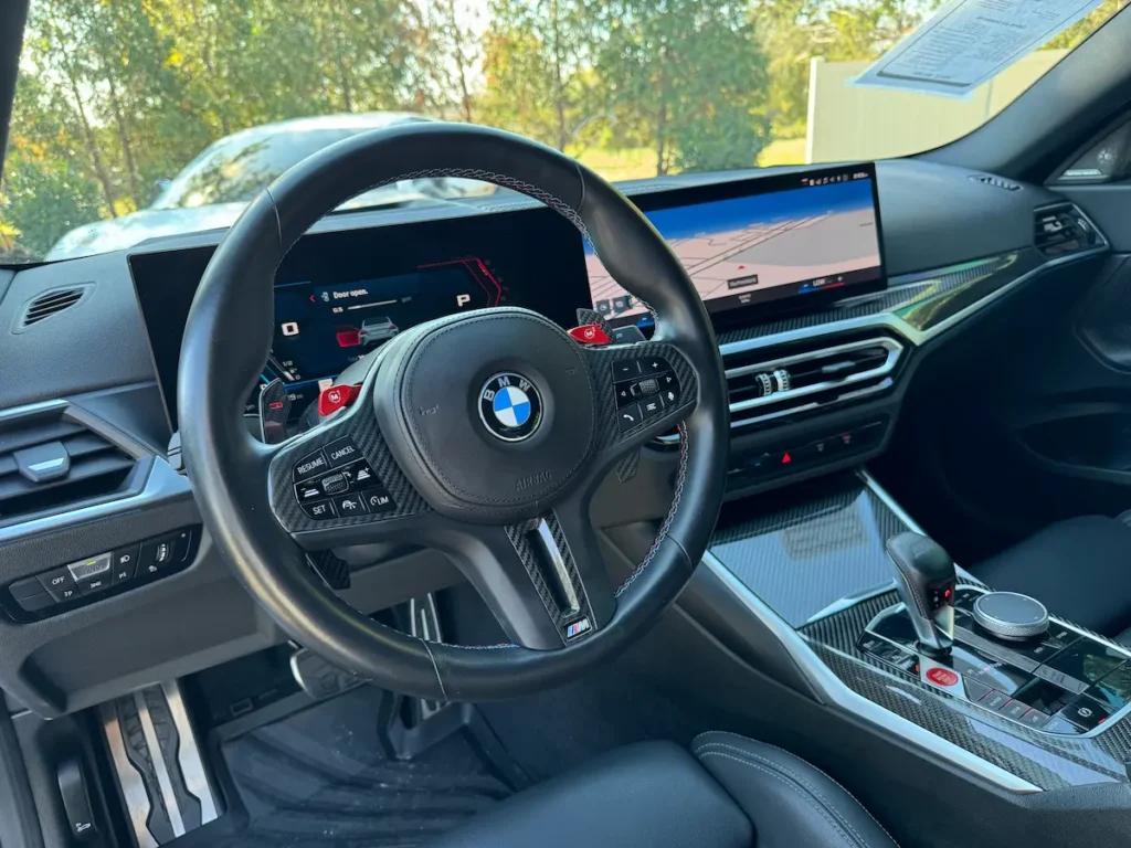 BMW M2 steering wheel with M drive mode buttons and digital instrument cluster