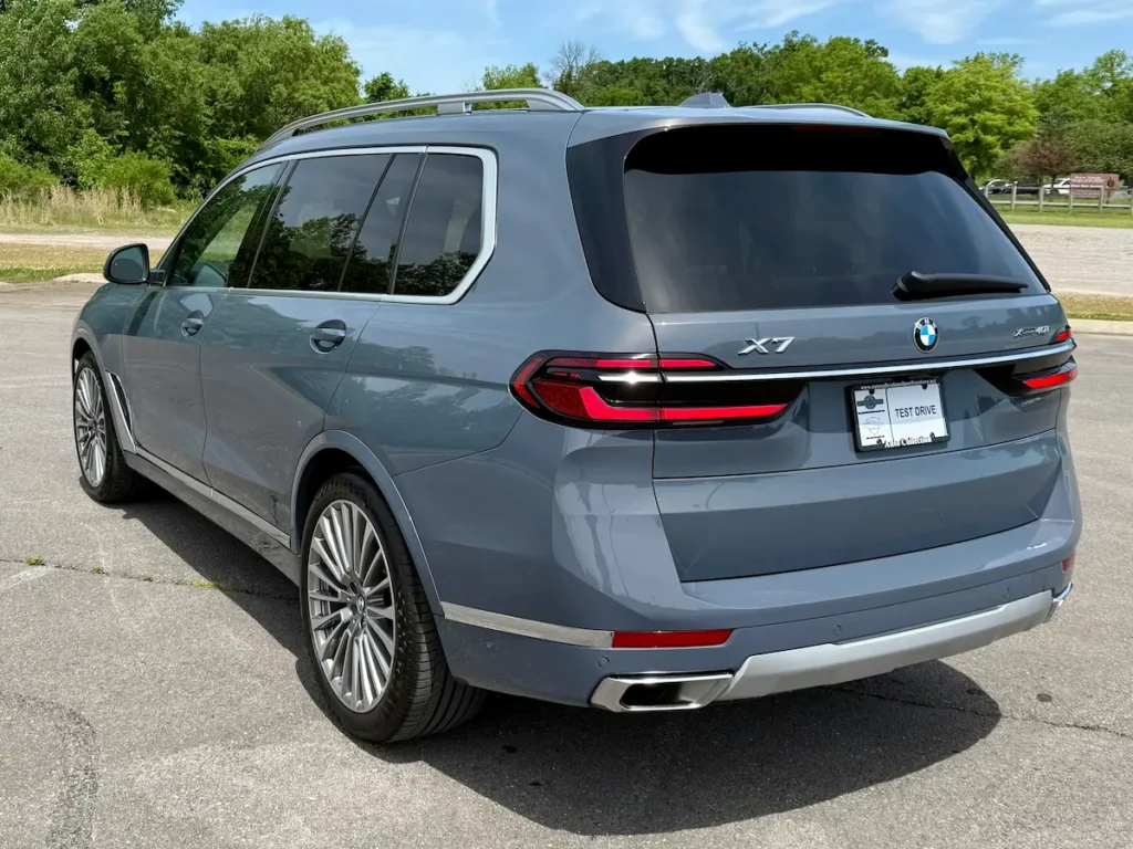 Rear three-quarter view of a blue-gray 2023 BMW X7 xDrive40i luxury SUV