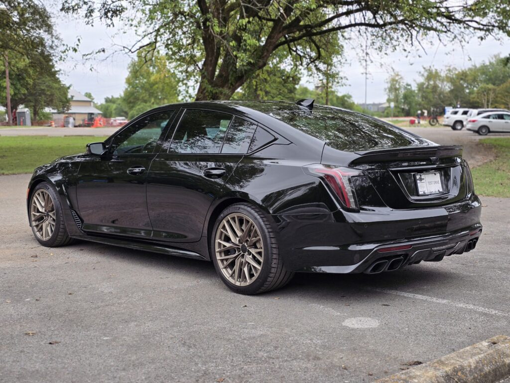 2023 Cadillac CT5-V Blackwing rear exterior view with quad exhaust, sculpted bodywork, and aerodynamic spoiler.