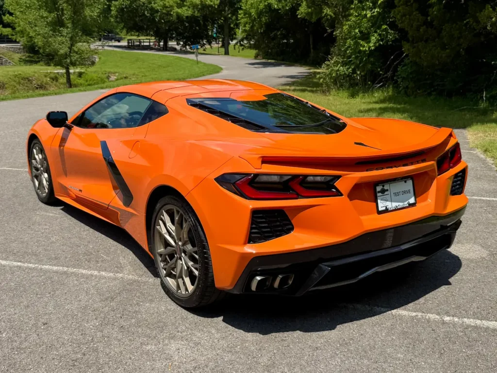 Rear and side view of a 2023 Chevrolet Corvette Stingray R in orange with bronze forged wheels.