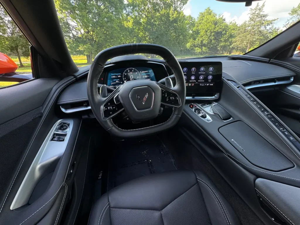 Interior dashboard and steering wheel of a 2023 Chevrolet Corvette Stingray R with digital display.