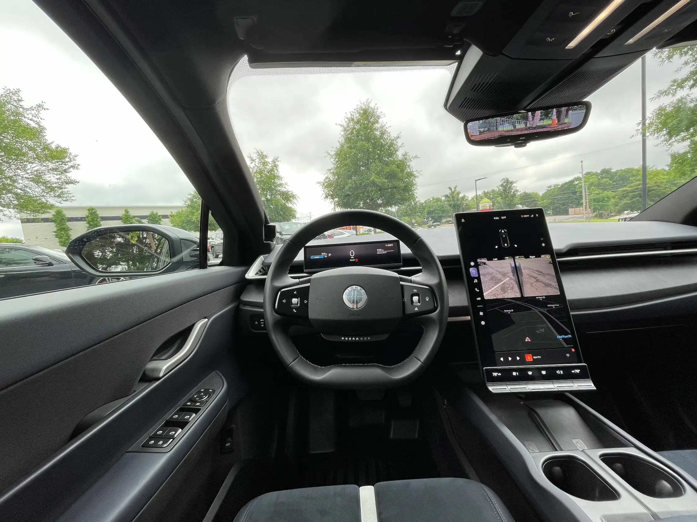 2023 Fisker Ocean One dashboard with a portrait touchscreen showing camera views, a digital instrument panel and steering wheel.