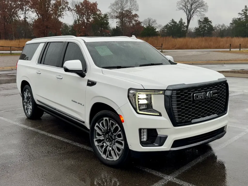 Front exterior view of a white 2023 GMC Yukon XL Denali parked at AutoPro Nashville.