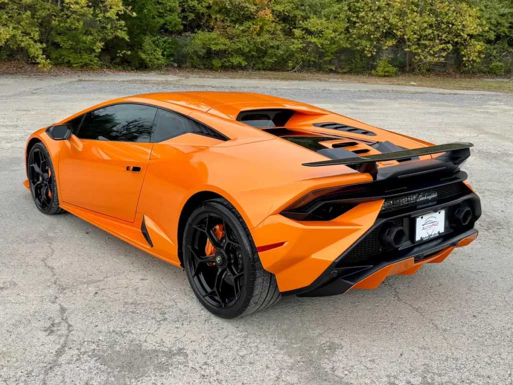 Rear exterior view of a 2023 Lamborghini Huracán in orange